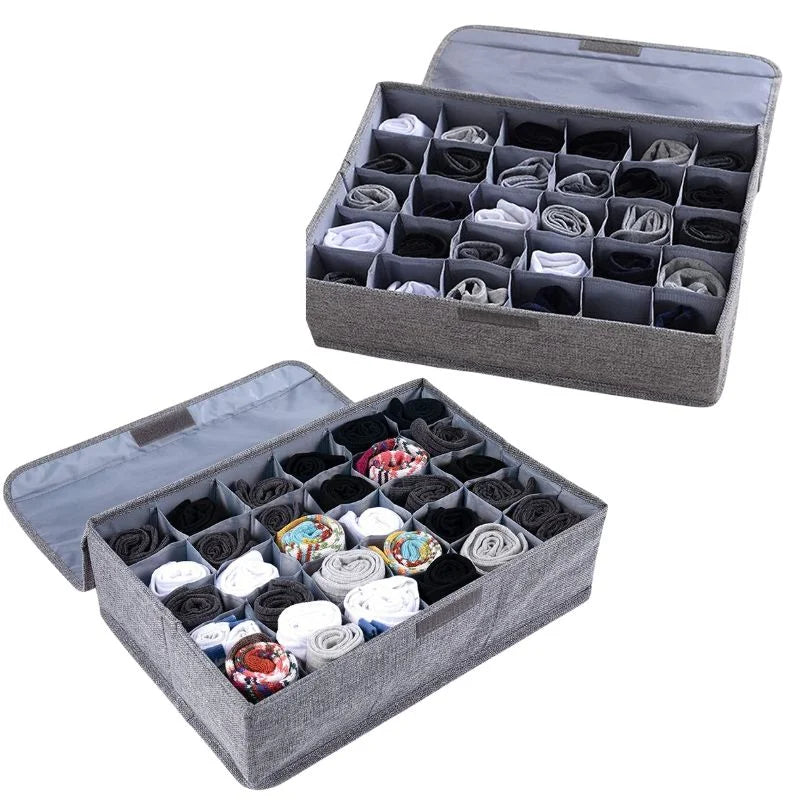 Gray fabric storage box with divided sections for organizing ties and socks on a white background