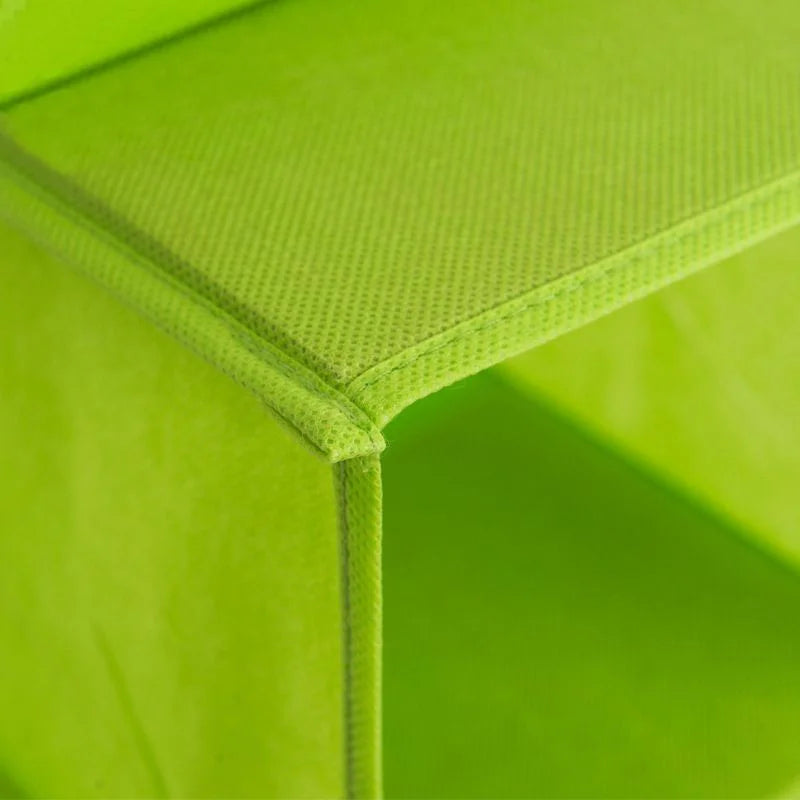 Close-up of a green plastic chair with a textured surface.