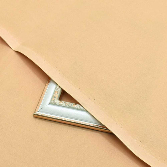 Men’s Unstitched Skin colour Hard Cotton Plain Suit Close-up of a gold decorative corner on beige fabric