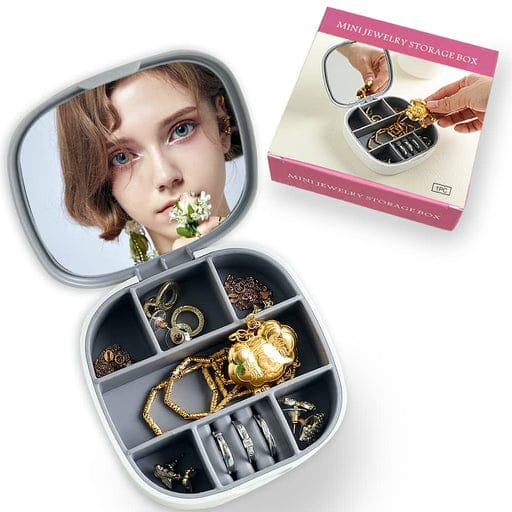 Necklace Organizer & Jewellery Box with Mirror Heart-shaped jewelry storage box with compartments filled with jewelry, next to its packaging.