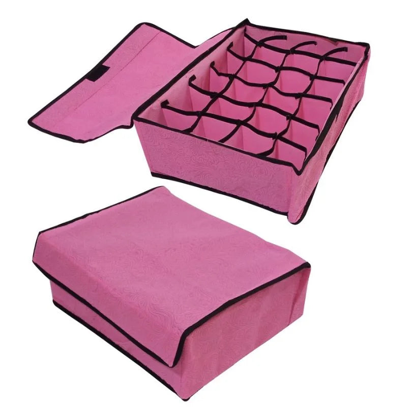 Pink jewelry organizer with grid compartments on a white background