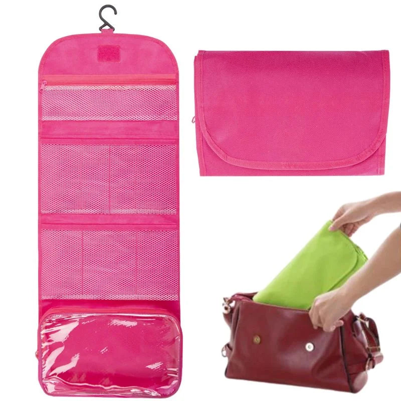 Pink travel organizer with hanging and flat designs, and a hand placing a green item into a red bag.