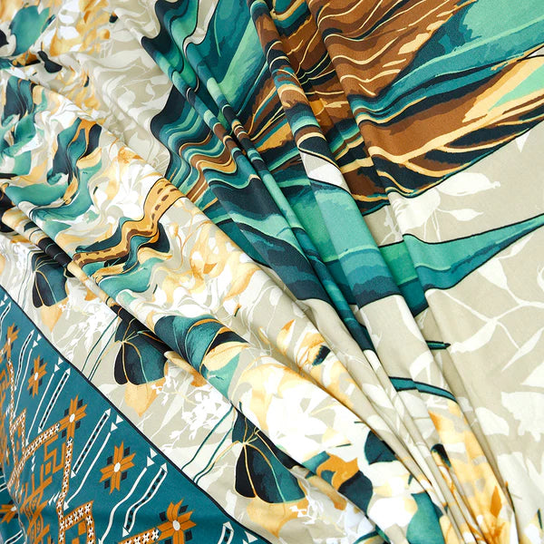 Close-up of patterned fabric with teal, brown, and beige colors.