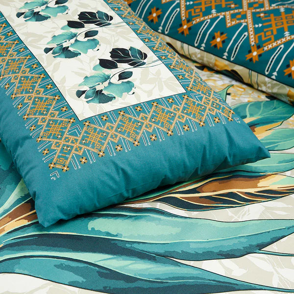 Teal and gold patterned pillow on a matching fabric background