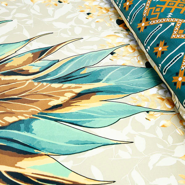 Close-up of fabric with blue and gold leaf pattern on a textured beige background