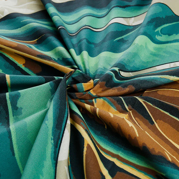 Close-up of fabric with abstract green, brown, and blue pattern