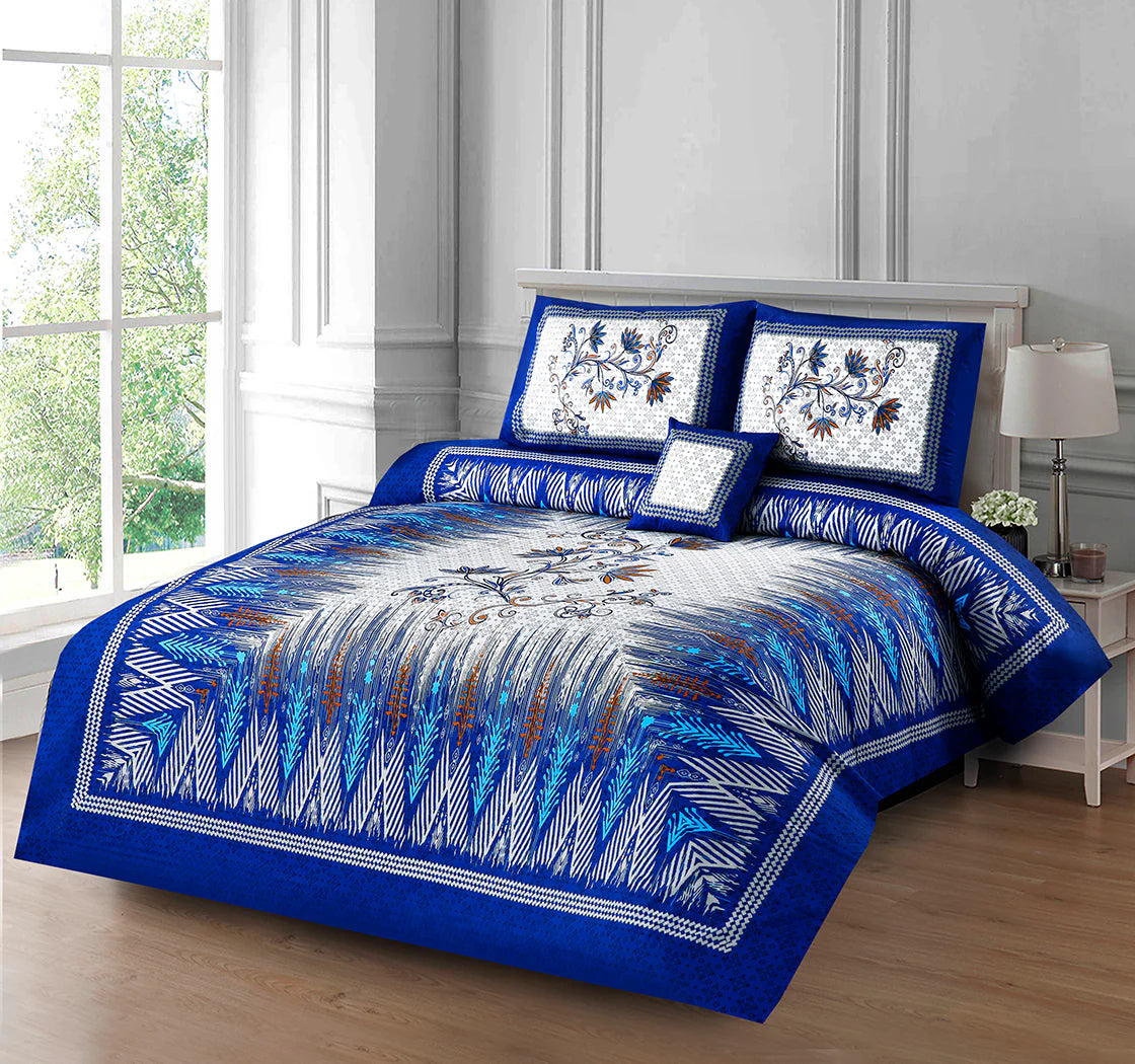 Blue and white patterned bedding set on a bed in a room with a window and lamp.