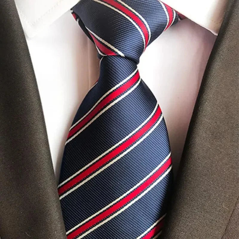 Navy blue tie with red and white stripes on a mannequin against a brown suit background